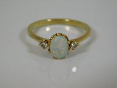 An 18ct gold ring set with opal & two diamonds