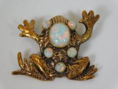 A yellow metal antique frog pendant set with five