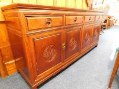 A 20thC. Chinese rosewood sideboard with four draw