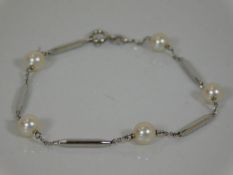 A white metal bracelet set with cultured pearls