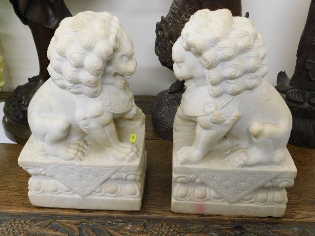 A pair of carved heavy Chinese alabaster foo lion