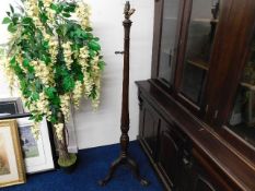 A well carved oak Edwardian standard lamp with bal