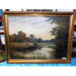 A framed 19thC. oil depicting cattle grazing by ri