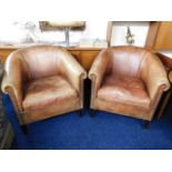 A pair of Amsterdam leather bucket chairs by Leath