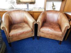 A pair of Amsterdam leather bucket chairs by Leath
