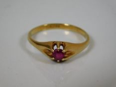 An 18ct yellow ring set with pink stone