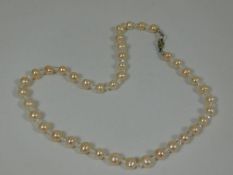 A set of pink cultured pearls set with crystal sty