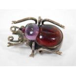 A silver mounted garnet & amethyst beetle brooch