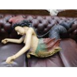 A large carved mermaid figure dated to chest 1877