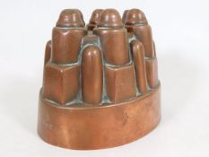 A Victorian copper jelly mould with castle design