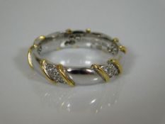 A fine two tone gold band set with diamonds