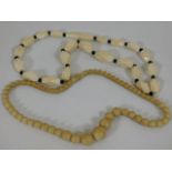 An antique ivory necklace twinned with one other