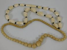 An antique ivory necklace twinned with one other