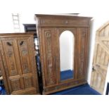 A Dutch 19thC. carved oak double wardrobe with cen