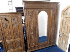 A Dutch 19thC. carved oak double wardrobe with cen