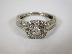An 18ct white gold ring with centre diamond set wi