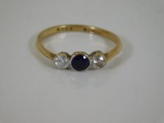 A yellow metal diamond & sapphire ring