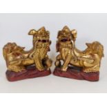 A pair of 19thC. Chinese carved Foo Dogs with gild