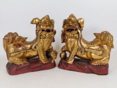 A pair of 19thC. Chinese carved Foo Dogs with gild