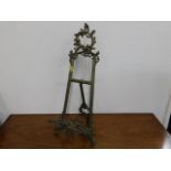 An ornate brass picture stand