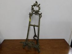 An ornate brass picture stand