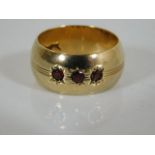 A 9ct gold & garnet band