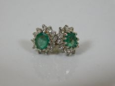 A pair of emerald & diamond 18ct gold earrings