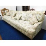 A pair of Victorian style two seater sofas, bought