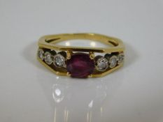 A yellow metal ring set with centre ruby & six dia