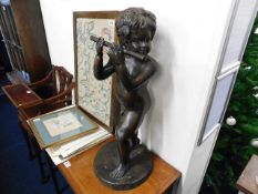 A large bronze figure of young boy playing the flu