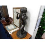 A large bronze figure of young boy playing the flu