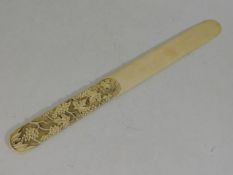 A 19thC. ivory page turner with grape & vine decor