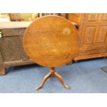 A Georgian oak tilt top table