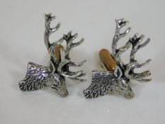 A pair of white metal stag cufflinks