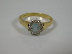 An 18ct gold aquamarine & diamond ring