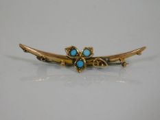 A yellow metal brooch set with turquoise