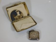 A small silver cigarette case twinned with silver