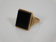 An art deco 9ct gold ring set with onyx