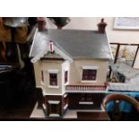 A large 1920's dolls house 36in high by 28in wide