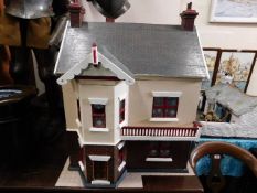 A large 1920's dolls house 36in high by 28in wide