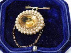 A Victorian yellow metal brooch set with natural p
