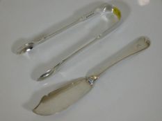 A pair of silver tongs twinned with fish knife