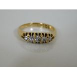 An 18ct gold ring set with five small diamonds