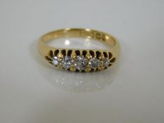 An 18ct gold ring set with five small diamonds