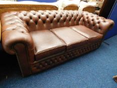 A brown leather chesterfield sofa