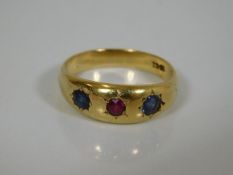 An 18ct gold ring set with two sapphires & a ruby