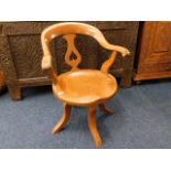 A 19thC. elm seated captains chair