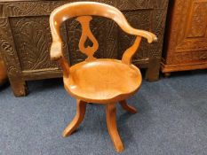 A 19thC. elm seated captains chair