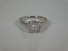 An 18ct white gold ring with centre diamond set wi
