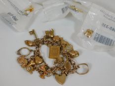 A 9ct gold charm bracelet with three others